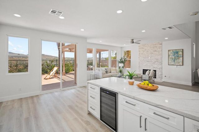 a kitchen with a sink and wooden floor