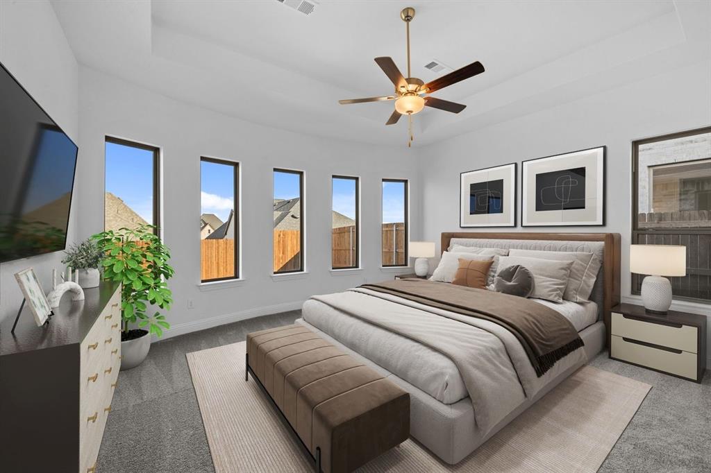 937 Mumms Drive Justin, TX 76247 - Photo 13 of 26 a bedroom with a large bed and a chandelier