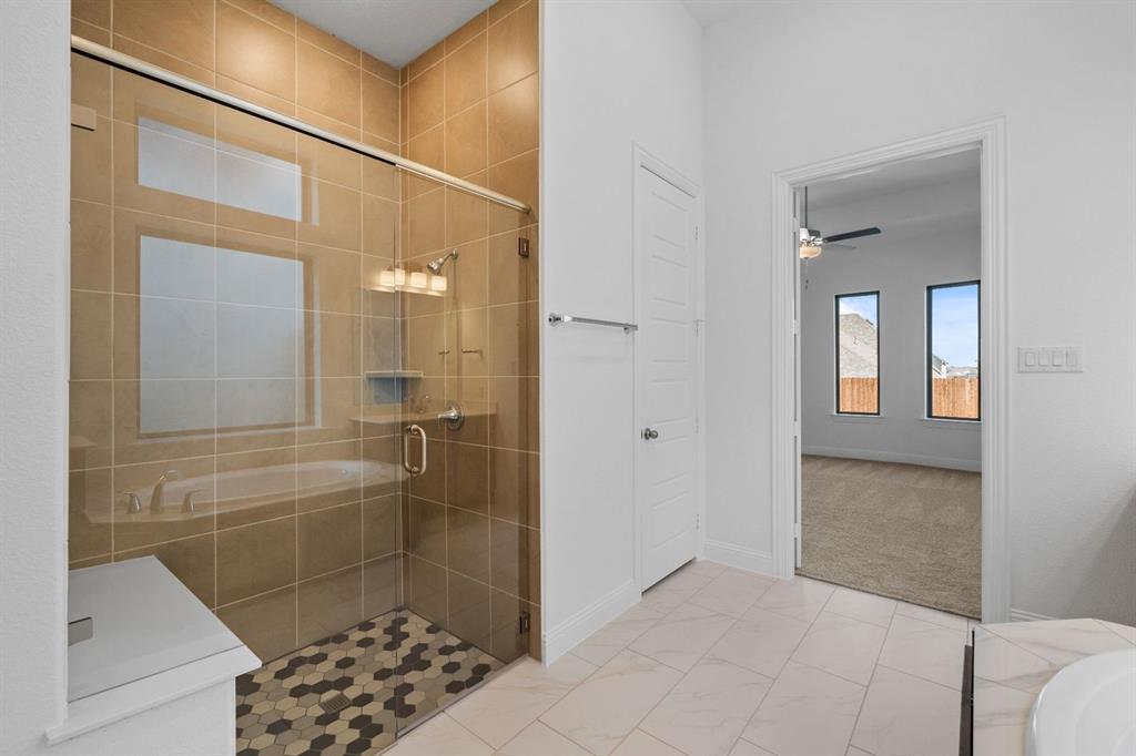 937 Mumms Drive Justin, TX 76247 - Photo 15 of 26 a bathroom with a glass shower door