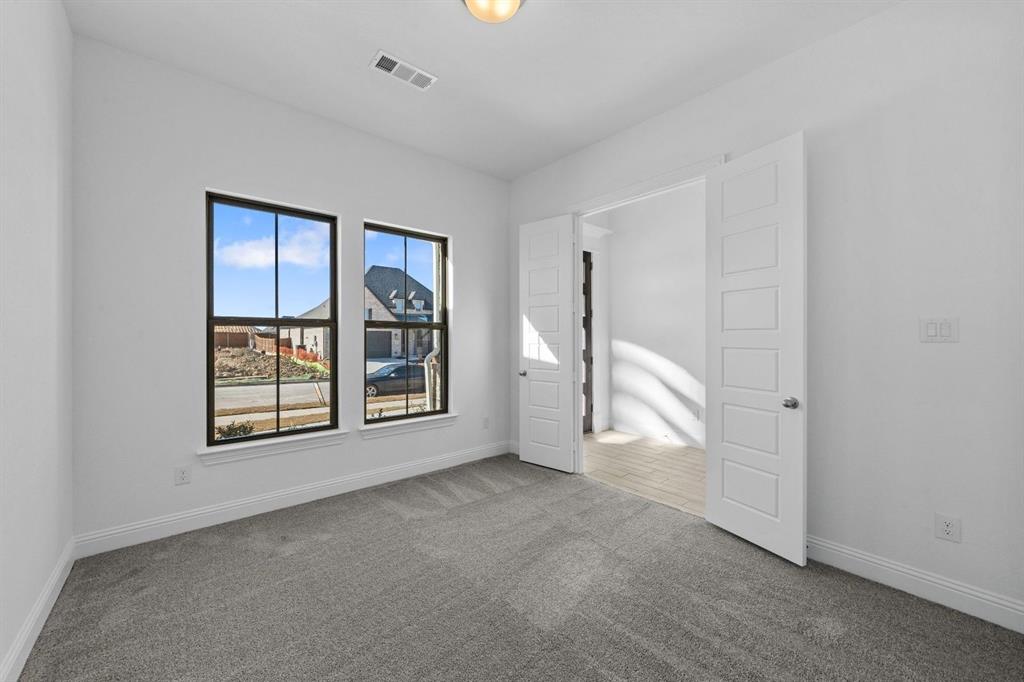 937 Mumms Drive Justin, TX 76247 - Photo 23 of 26 an empty room with windows and closet