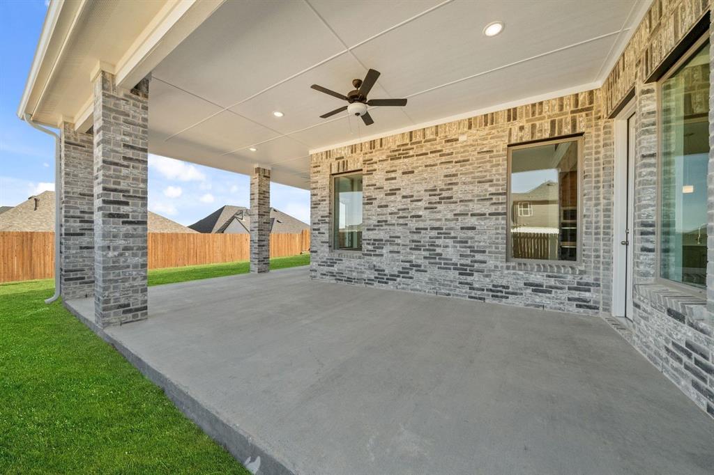 937 Mumms Drive Justin, TX 76247 - Photo 24 of 26 a view of a house with a yard and garage