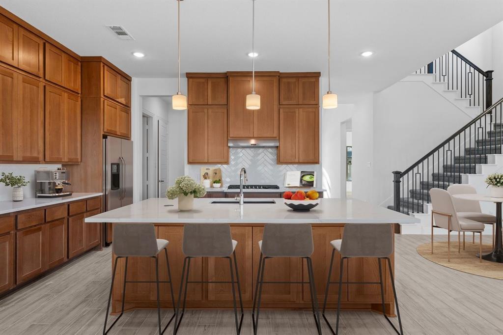937 Mumms Drive Justin, TX 76247 - Photo 3 of 26 a kitchen with stainless steel appliances kitchen island granite countertop a sink and cabinets