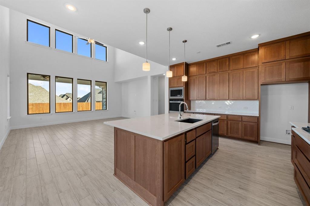 937 Mumms Drive Justin, TX 76247 - Photo 6 of 26 a kitchen with a stove and a kitchen island