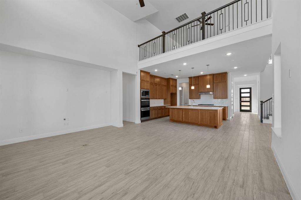 937 Mumms Drive Justin, TX 76247 - Photo 8 of 26 a view of a kitchen with a sink and a refrigerator