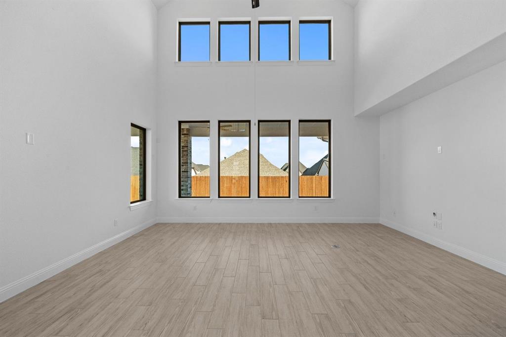 937 Mumms Drive Justin, TX 76247 - Photo 9 of 26 wooden floor in an empty room with a window