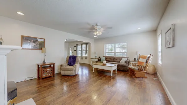 a living room with furniture and wooden floor