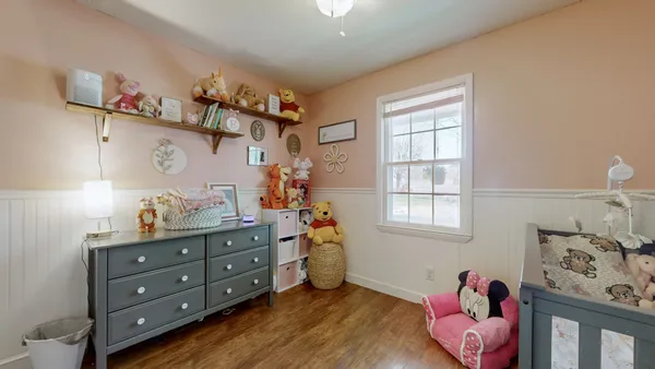 a bedroom with a baby bed baby crib and a window