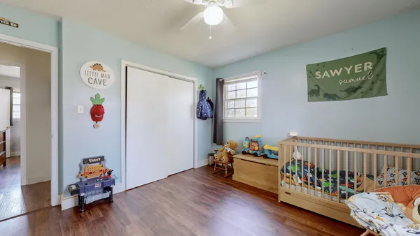 a bedroom with furniture and wooden floor