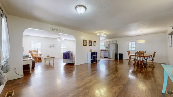 a view of a dining room with furniture and wooden floor
