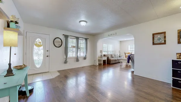 a living room with furniture and a clock