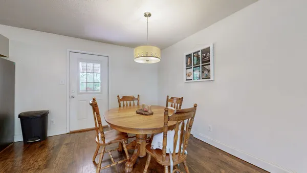 a view of a dining room with a table and chairs