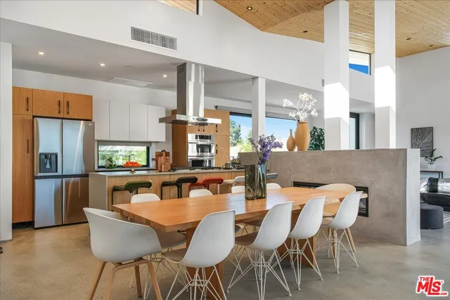 a dining room with furniture and a wooden floor