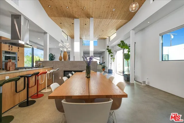 a dining room with furniture a rug and wooden floor