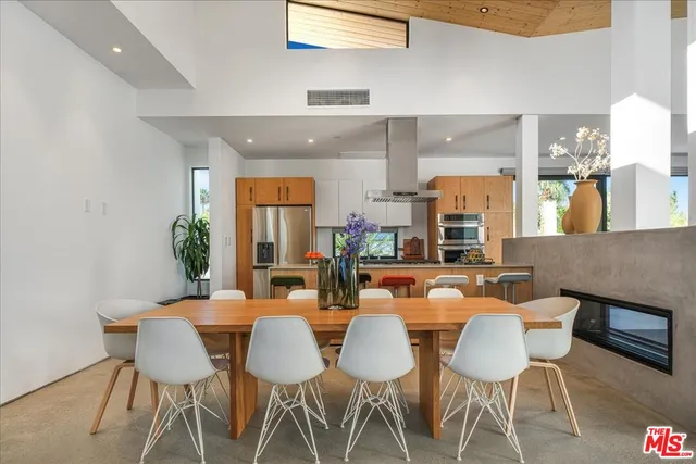 a dining room with furniture a rug and wooden floor