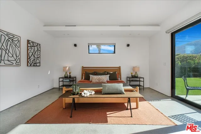 a living room with furniture a rug and a large window