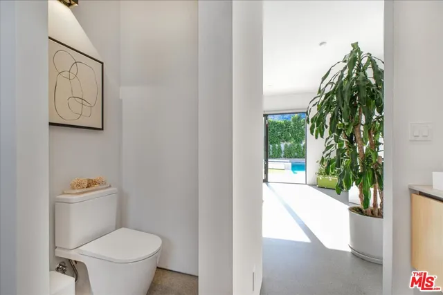 a white toilet sitting next to a shower curtain