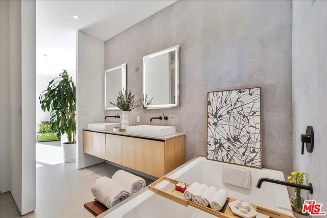 a bathroom with a bathtub sink and mirror
