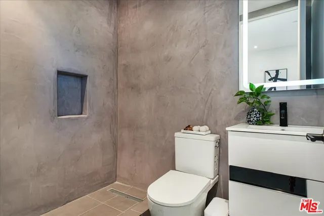 a white toilet sitting next to a bathroom sink