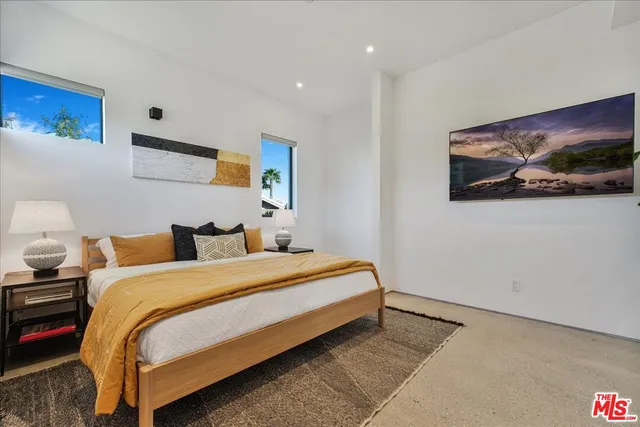 a bedroom with bed and wall painting