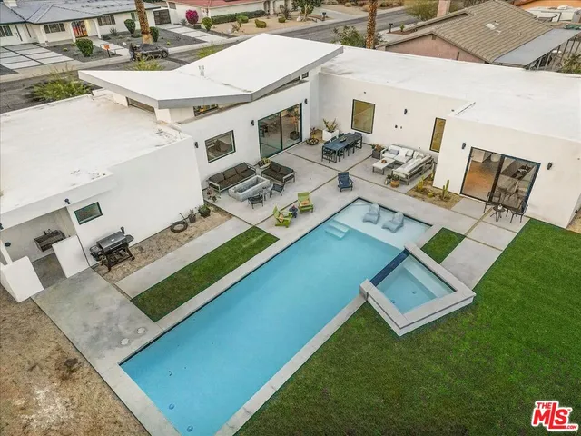 a aerial view of a house with a backyard