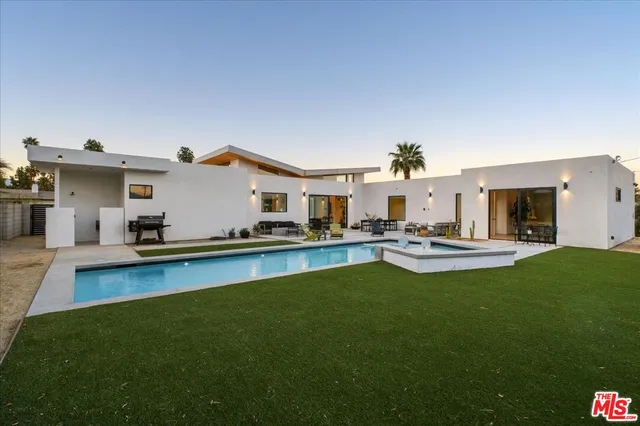 a view of a house with swimming pool yard and a patio