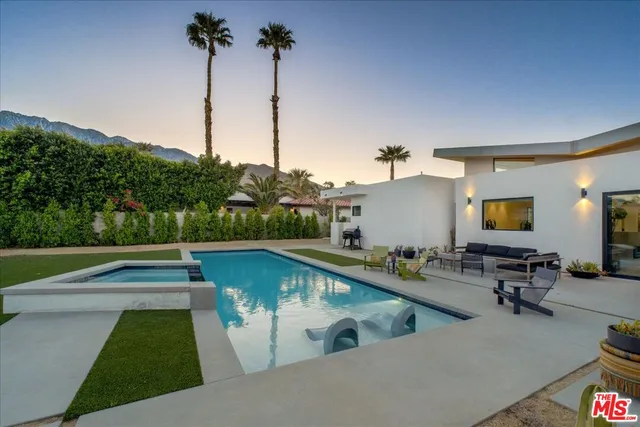 a view of a swimming pool with a chair and tables