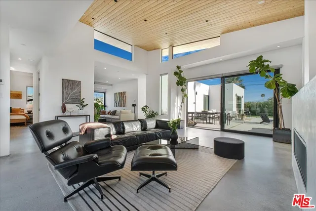 a living room with furniture a chandelier and a table