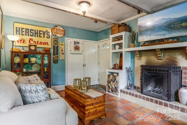 a living room with furniture a flat screen tv and a fireplace