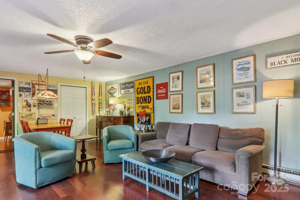 a living room with furniture ceiling fan and a window
