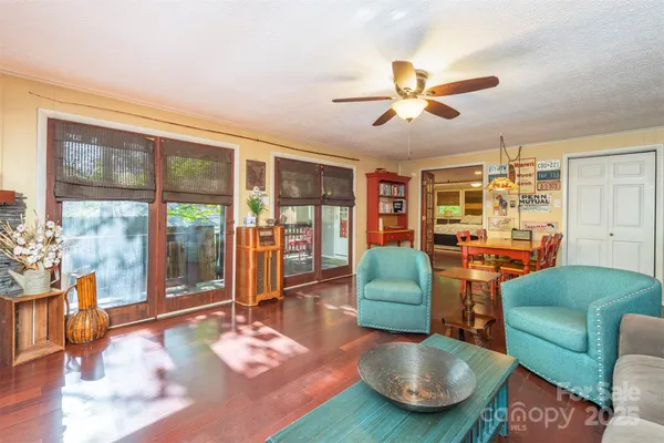 a living room with furniture and a floor to ceiling window