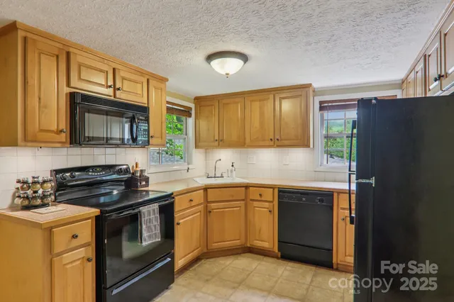 a kitchen with a sink stove and microwave