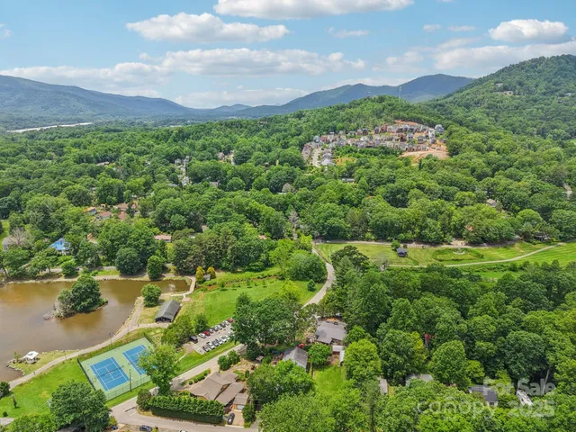 an aerial view of a houses with outdoor space and lake view