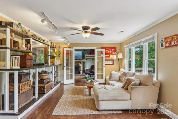 a living room with furniture fireplace and a large window