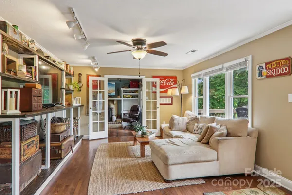 a living room with furniture fireplace and a large window