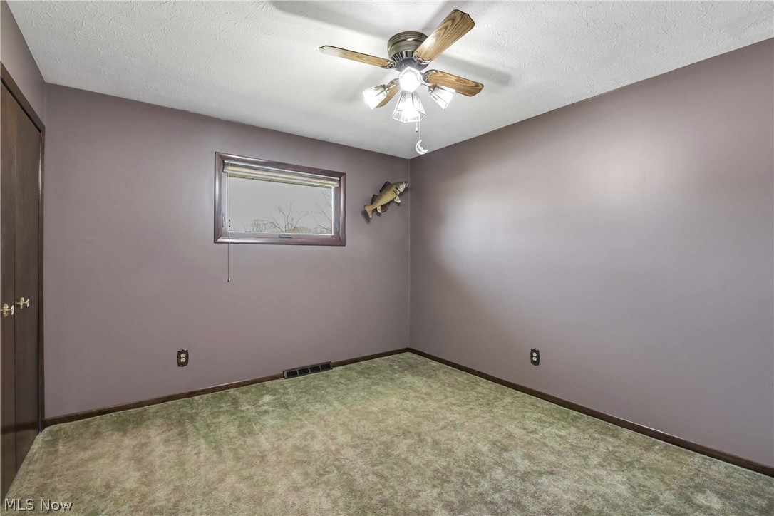 7350 Ames Road Parma, OH 44130 - Photo 26 of 50 View of 3rd bedroom with purple walls, window, ceiling fan/light and carpet