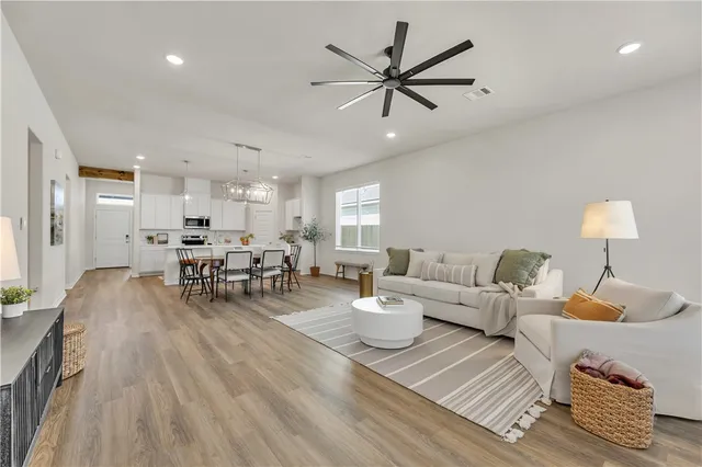 a living room with furniture and a wooden floor