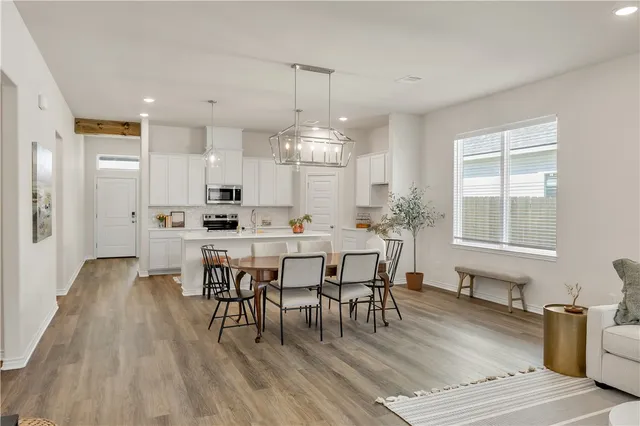 a view of a dining room with furniture window and wooden floor