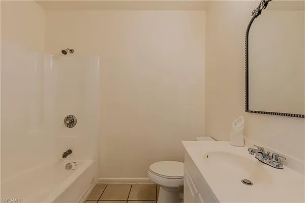 a white bath tub sitting next to a white toilet and sink