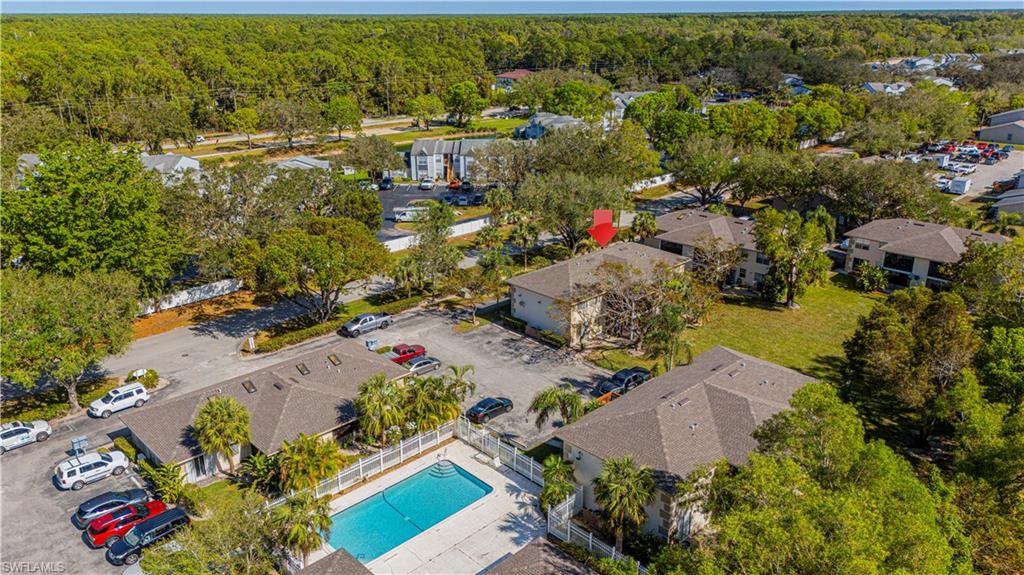5434 16th Place Southwest, Unit D3 Golden Gate, FL 34116 - Photo 14 of 17 an aerial view of residential houses with outdoor space