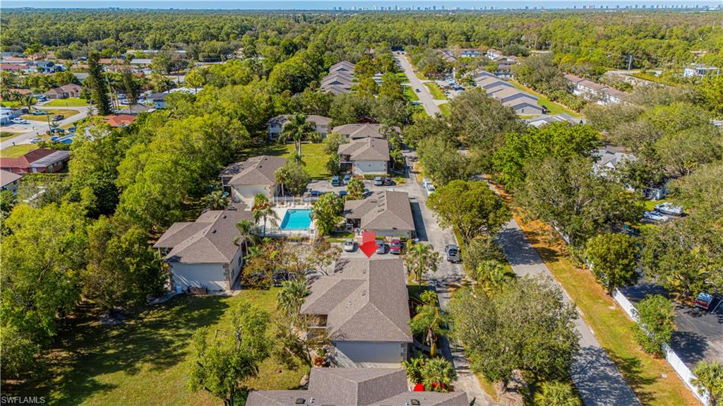 5434 16th Place Southwest, Unit D3 Golden Gate, FL 34116 - Photo 16 of 17 an aerial view of residential houses with outdoor space and trees