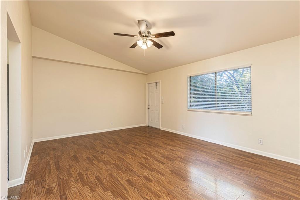 5434 16th Place Southwest, Unit D3 Golden Gate, FL 34116 - Photo 8 of 17 wooden floor in an empty room with a window