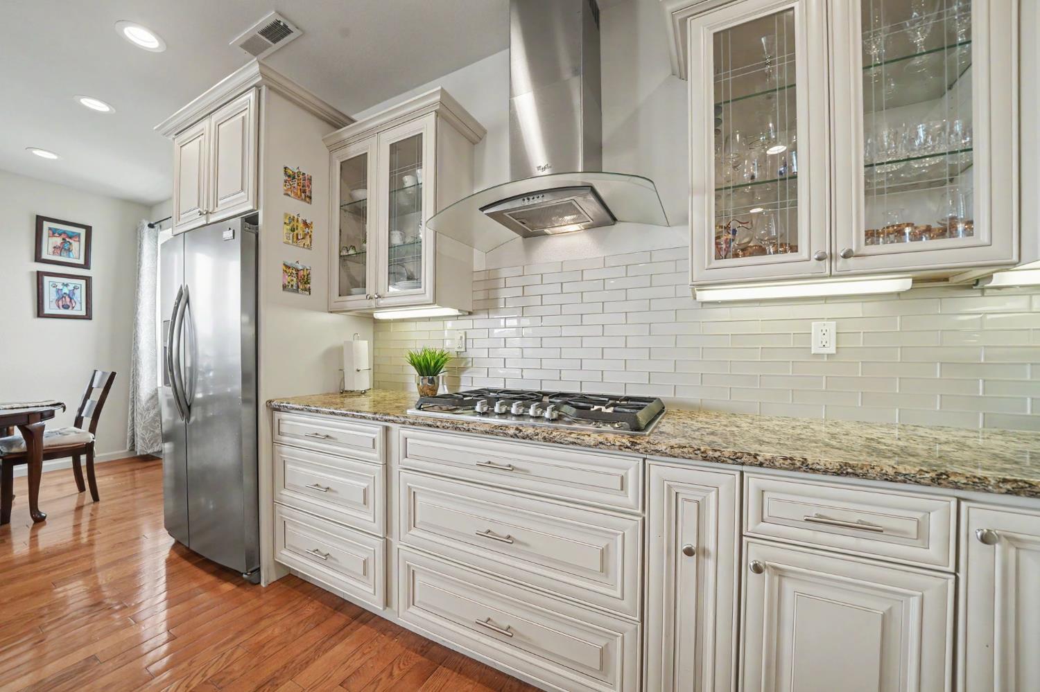 6066 Bluff View Road Copperopolis, CA 95228 - Photo 27 of 96 a kitchen with granite countertop white cabinets and white appliances