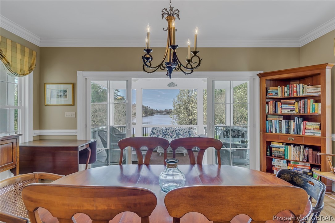 507 Sunnybank Road Reedville, VA 22539 - Photo 28 of 48 Dining area featuring ornamental molding, hardwood / wood-style floors, and a notable chandelier