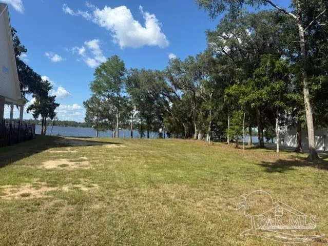 a swimming pool with trees in the background