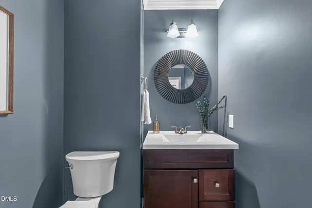a kitchen with stainless steel appliances granite countertop a dining table chairs and white cabinets
