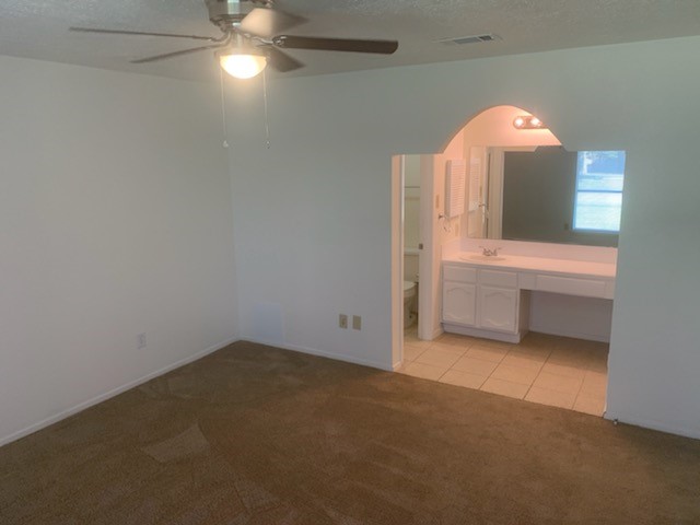 4419 Stallion Brook Lane Spring, TX 77388 - Photo 9 of 15 an empty room with a chandelier fan and windows