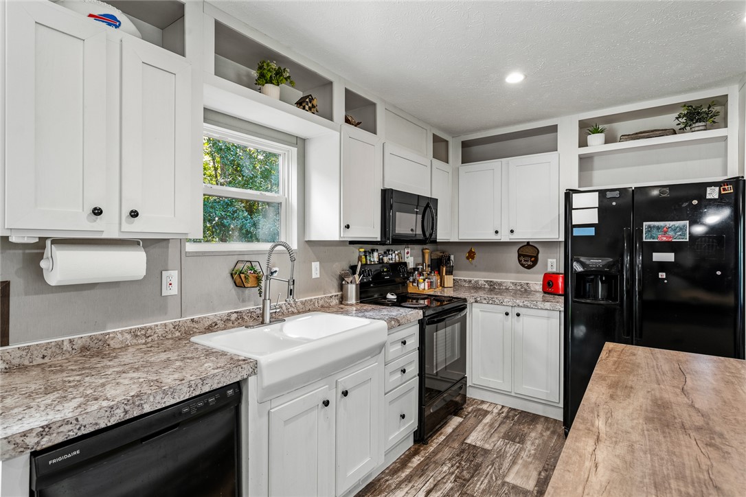429 Gibson Road Anderson, SC 29625 - Photo 12 of 47 Gleaming cabinetry and stone-look countertops define this well-appointed kitchen space with durable wood-look flooring.