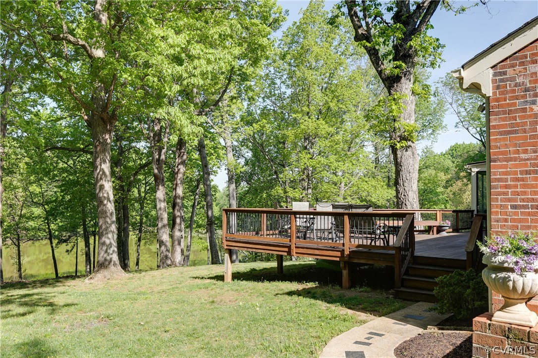 2780 East Brigstock Road Midlothian, VA 23113 - Photo 38 of 50 a view of a wooden chairs and fire pit in the backyard