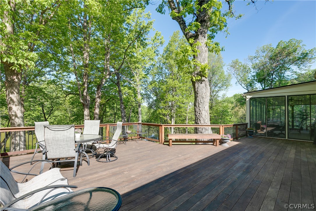 2780 East Brigstock Road Midlothian, VA 23113 - Photo 39 of 50 a view of a patio with table and chairs potted plants and wooden floor