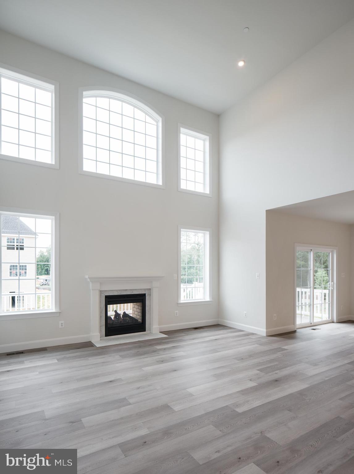 8528 Rocky Springs Road Frederick, MD 21702 - Photo 23 of 93 a view of an empty room with wooden floor and a window